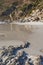 A rocky coastline at a beach in Cape Town with mountains in the background and copyspace. View of a shore with rocks at