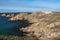 The rocky coastline of Beg er Vachif peninsula in west of Houat island in French Brittany. Ruins of Beniguet bastion are at right