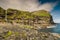 Rocky coastline with cliffs and waterfalls at village Mikladalur, Kalsoy island, Faroe Islands