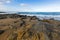 Rocky coastline on Four Mile Creek beach in Tasmania, Australia