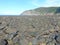 Rocky coastline with impressive distant cliffs.