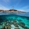 Rocky coastline with a lighthouse and seabed with rocks and sand underwater