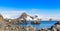 Rocky coastline panorama with snow mountains and polar research