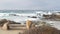 Rocky craggy ocean coast, sea waves, Monterey California. Wooden empty bench.