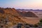 Rocky desert at dusk, colorful sunset over the Namib desert, Namibia, Africa, glowing rocks and canyon.