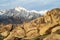 Rocky desert landscape and snowy Sierra Nevada mountain range in Alabama Hills California