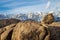 Rocky desert landscape and snowy Sierra Nevada mountain range in Alabama Hills California