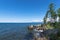 Rocky eastern coast of Lake Baikal in summer. Turquoise colored water under a blue sky. Republic of Buryatia, Russia