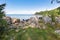 Rocky eastern coast of Lake Baikal in summer. Turquoise colored water under a blue sky. Republic of Buryatia, Russia