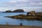 The rocky entrance to the small harbor at Ballintoy on the North Antrim Coast of Northern Ireland on a calm spring day.