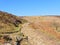 Rocky footpath winding up to Derwent Moor in the early spring sunlight