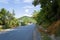 The rocky and green coast, in Europe, in Greece, in Epirus, towards Igoumenitsa, by the Ionian Sea, in summer, on a sunny day