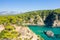 The rocky and green coast, in Europe, in Greece, in Epirus, towards Igoumenitsa, by the Ionian Sea, in summer, on a sunny day