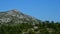 Rocky hill of Velebit mountain with some vegetation during hot summer day. Location near Paklenica national park, Croatia