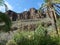 Rocky landscape of barranco de los palmitos with cacti, plam trees and exotic plants. Gran Canaria, Canary Islands