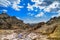 The rocky landscape with gulls under the sky with clouds