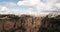 Rocky landscape of Ronda city with Puente Nuevo Bridge and buildings, Andalusia, Spain