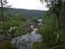 A rocky landscape with trees and rocks in the foreground. Suna River, Poor Porog Waterfall, Girvas