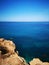 Rocky mediterranean seashore with azure and turquoise color water at Malta