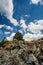 Rocky mound and blue sky with clouds