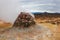 A Rocky Mound Steams With Sulfuric Fumes In Geothermal Area