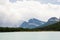 Rocky mountain peaks towering over evergreen forest and lake