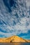 Rocky mountain shore and blue sky with white clouds.  The Coast Of The Sea Of Cortez. Mexico