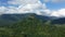 A rocky mountain surrounded by lush green forests