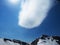 Rocky Mountains ski resort Gorky-gorod. Skiers on the mountain. Cloud trace of metiorite. Russia Sochi