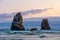 Rocky outrcrops near the Haystack Rock at dusk or sunset, Cannon Beach, Oregon Coast scenery, US route 101, OR,