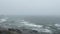 rocky panorama panning coastal shore waves shoreline mist fog cold ocean landscape coastline