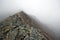 Rocky pass in haze and fog.Sayan mountains.Russia.