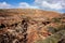 Rocky path in a dry trough of a creek leading to Pot Alley Beach in Kalbarri National Park, Western Australia