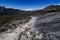 rocky path near punta union in the trekking of the quebrada santa cruz in peru with snowy mountain pucaraju