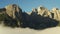 Rocky peak of giant Alps against clear blue sky at sunrise