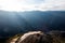 Rocky peak overlooking ridge way under sunlight