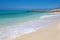 A rocky peninsula protects a perfect white sand beach on the island of Miyakojima, Okinawa, Japan