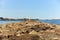 Rocky pier that surrounds the harbour. Beacon at the end of the pier