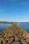 Rocky pier that surrounds the harbour. Beacon at the end of the pier