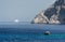 A rocky promontory, blue sea and a ship on the horizon. Rhodes island. Greece