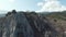 Rocky ridge on background of mountain landscape on sunny day. Shot. Small rocky mountain on background of mountain