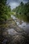 Rocky Riverbank Under Overcast Sky