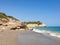 Rocky sandy beach, coastline with turquoise sea, wave splash, Spain