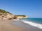 Rocky sandy beach, coastline with turquoise sea, wave splash, Spain