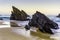 Rocky and sandy beach at sunrise, Portugal