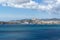 Rocky sandy coast at the sea with blue clean water and city view. Ibiza island, Spain