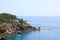 Rocky sea coast covered by pines in Kemer, Antalya, Turkey