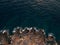 Rocky sea coast, waves hitting the rocks, aerial top view.