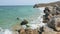 Rocky sea coastline on island on sunny summer day