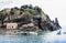 Rocky sea shore of Acitrezza next to Cyclops islands with island on background, Catania, Sicily, Italy